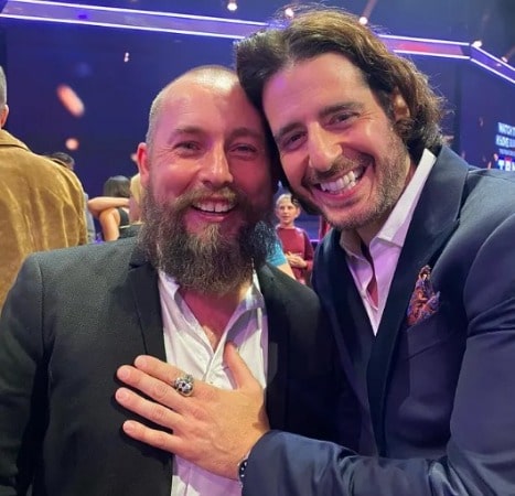 Picture of Jonathan Roumie in a blue suit with his friend at Grand Ole Opera House.